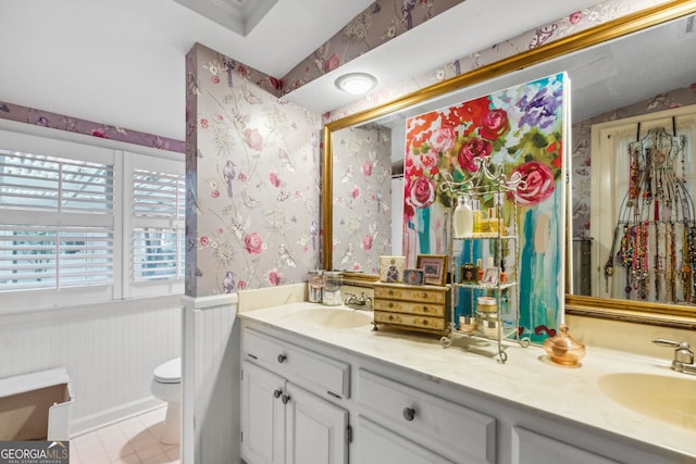 full bath with wallpapered walls, toilet, a wainscoted wall, tile patterned flooring, and vanity