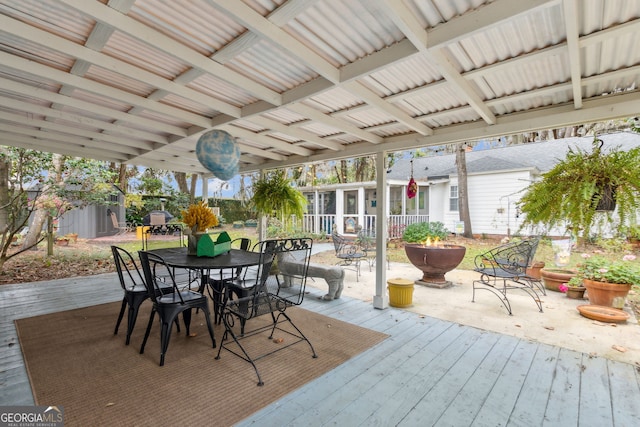 exterior space with outdoor dining space, a sunroom, and a deck