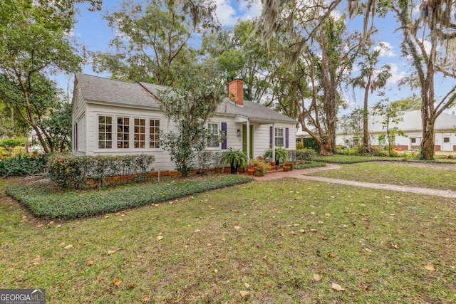 ranch-style house featuring crawl space, a chimney, and a front yard