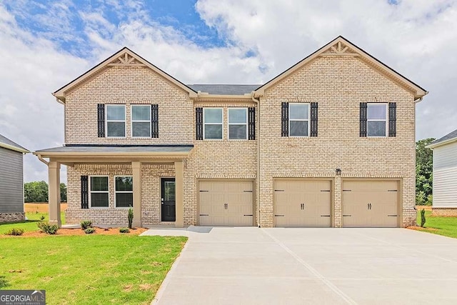 view of front of house with a garage, a front yard, brick siding, and driveway