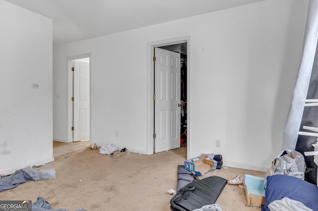111 Laurel Oak Ln, Warner Robins, GA 31093 - unfurnished bedroom featuring concrete flooring and a walk in closet