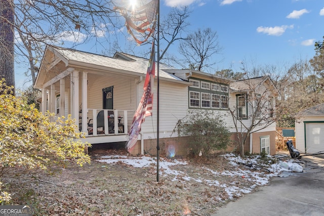 view of snow covered exterior featuring a porch