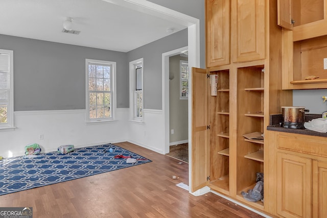 111 Laurel Oak Ln, Warner Robins, GA 31093 - interior space with dark countertops, wood finished floors, visible vents, and light brown cabinetry
