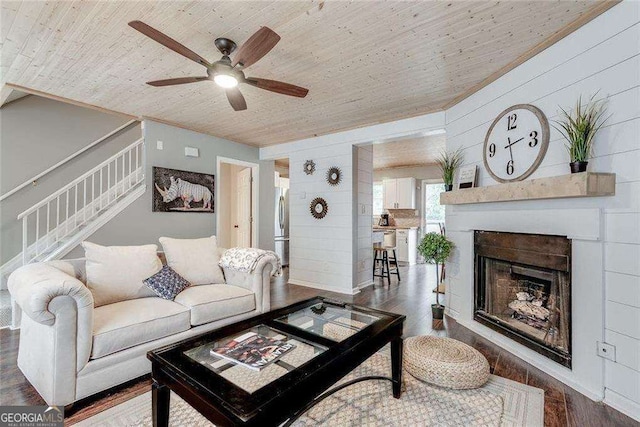 living area with stairs, wooden ceiling, a fireplace, and wood finished floors