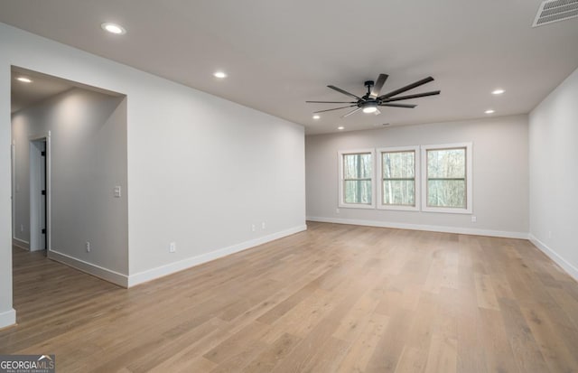 empty room with recessed lighting, visible vents, light wood-style flooring, and baseboards