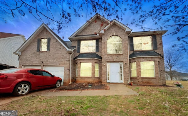 view of front of house featuring a garage and brick siding