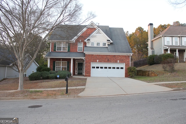 view of front of property with concrete driveway, brick siding, a shingled roof, and fence