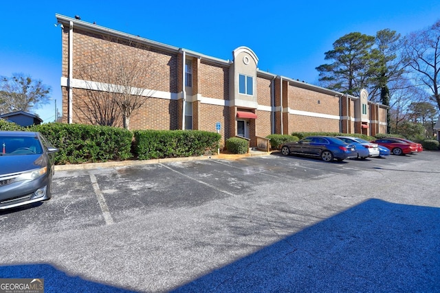 view of building exterior featuring uncovered parking