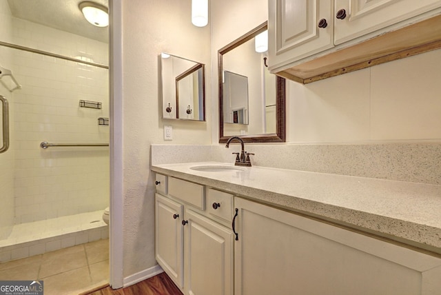 full bathroom with toilet, a shower stall, and vanity