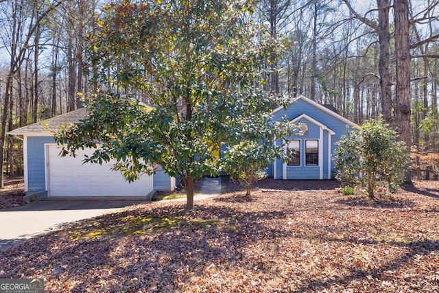 obstructed view of property with driveway and a garage