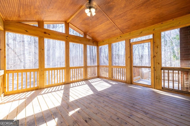 unfurnished sunroom with lofted ceiling, wooden ceiling, and a ceiling fan