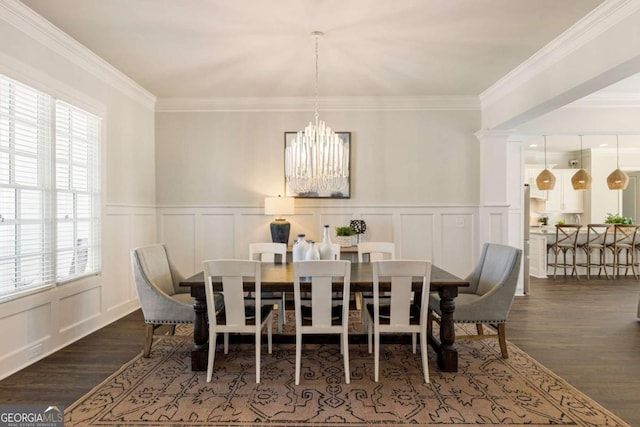 dining area featuring crown molding, dark wood-style flooring, a notable chandelier, and a decorative wall