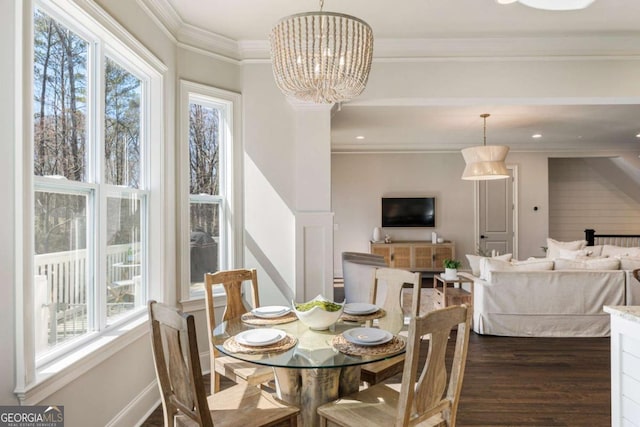 dining space featuring ornamental molding, dark wood-style flooring, baseboards, and an inviting chandelier