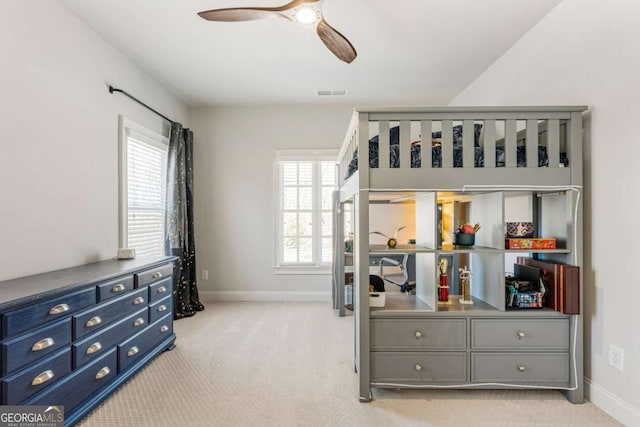 bedroom featuring baseboards, ceiling fan, visible vents, and light colored carpet