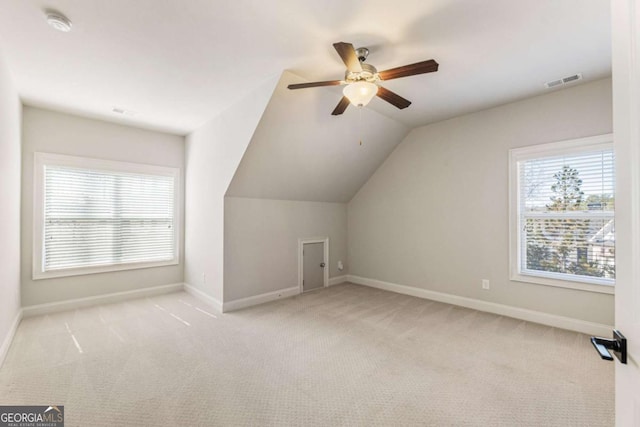 bonus room with vaulted ceiling, carpet, visible vents, and baseboards