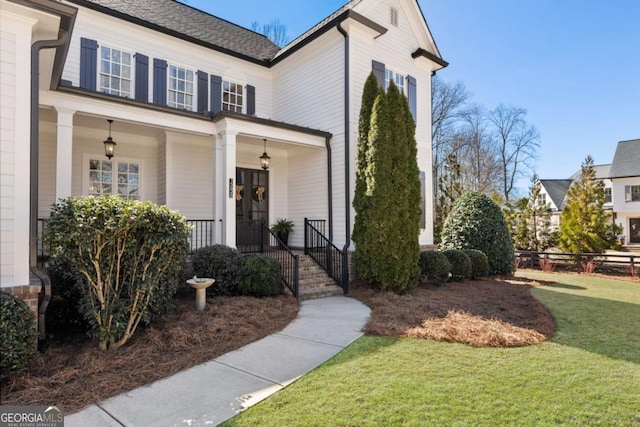 doorway to property with a yard