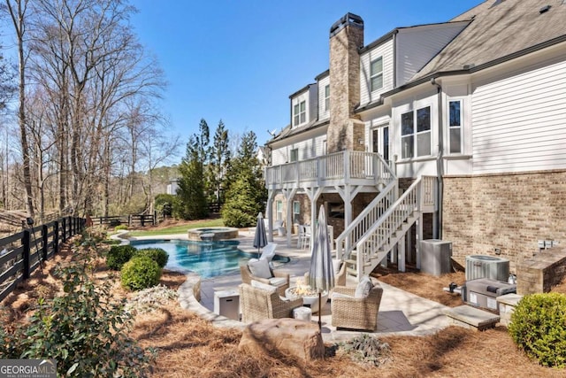 rear view of property featuring a chimney, central air condition unit, stairway, a patio area, and fence