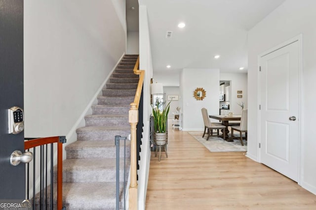 foyer featuring stairway, recessed lighting, light wood-style flooring, and baseboards