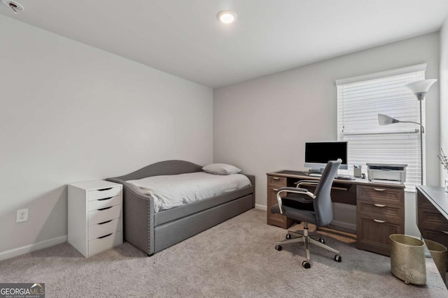 bedroom featuring baseboards and light colored carpet