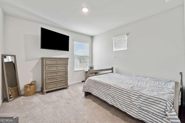 bedroom featuring carpet and baseboards