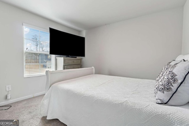 bedroom featuring carpet and baseboards