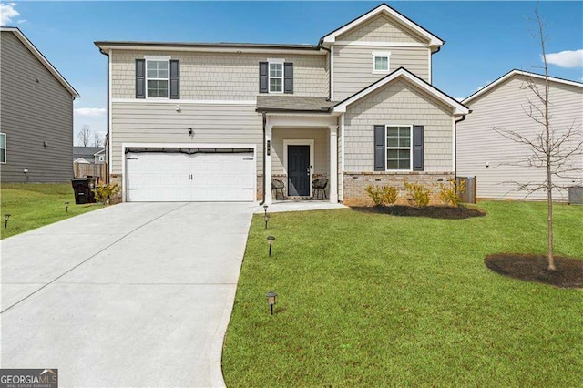 craftsman house featuring a garage, concrete driveway, and a front yard