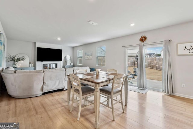 dining room featuring baseboards, light wood finished floors, visible vents, and recessed lighting