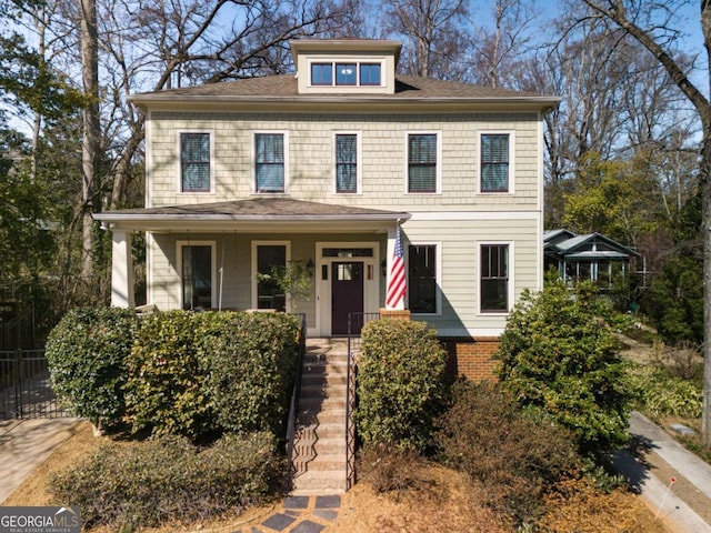 american foursquare style home with covered porch