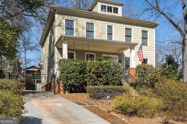 traditional style home with covered porch and a gate