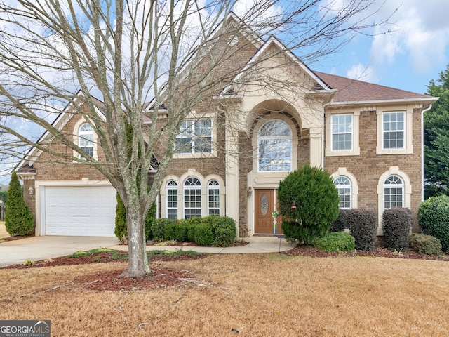 view of front of home featuring concrete driveway, brick siding, and a shingled roof