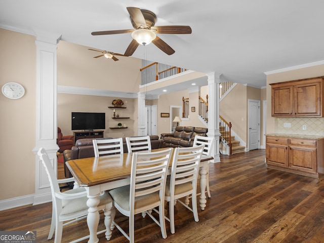 dining room with crown molding, stairway, decorative columns, and dark wood-style flooring