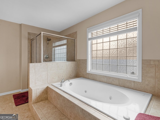 full bath featuring tile patterned floors, a tub with jets, and a tile shower