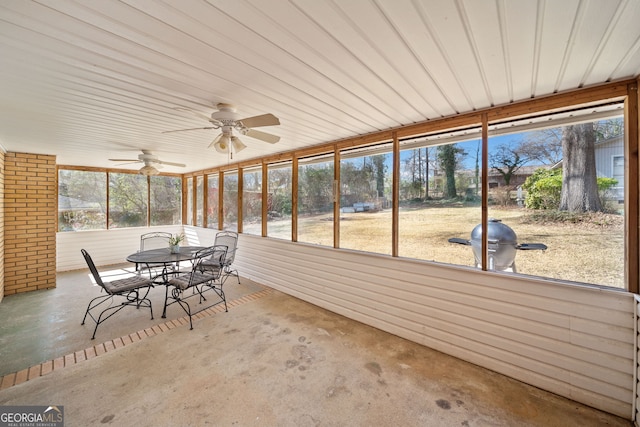 unfurnished sunroom with a wealth of natural light and ceiling fan