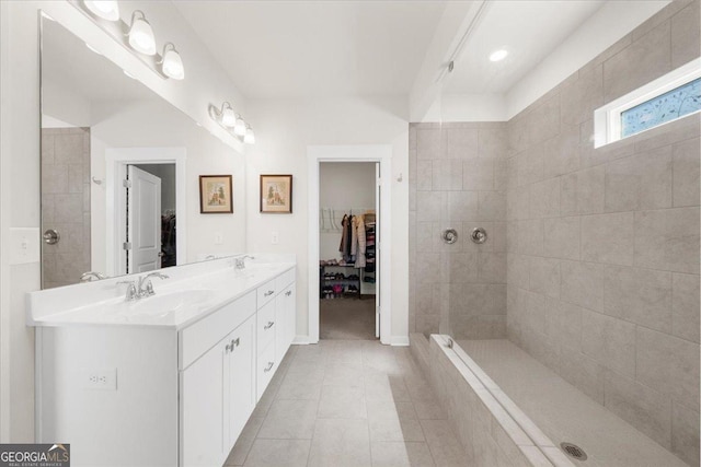 2401 Cotton Gin Row, Jefferson, GA 30549 - bathroom featuring a walk in closet, a tile shower, a sink, and tile patterned floors