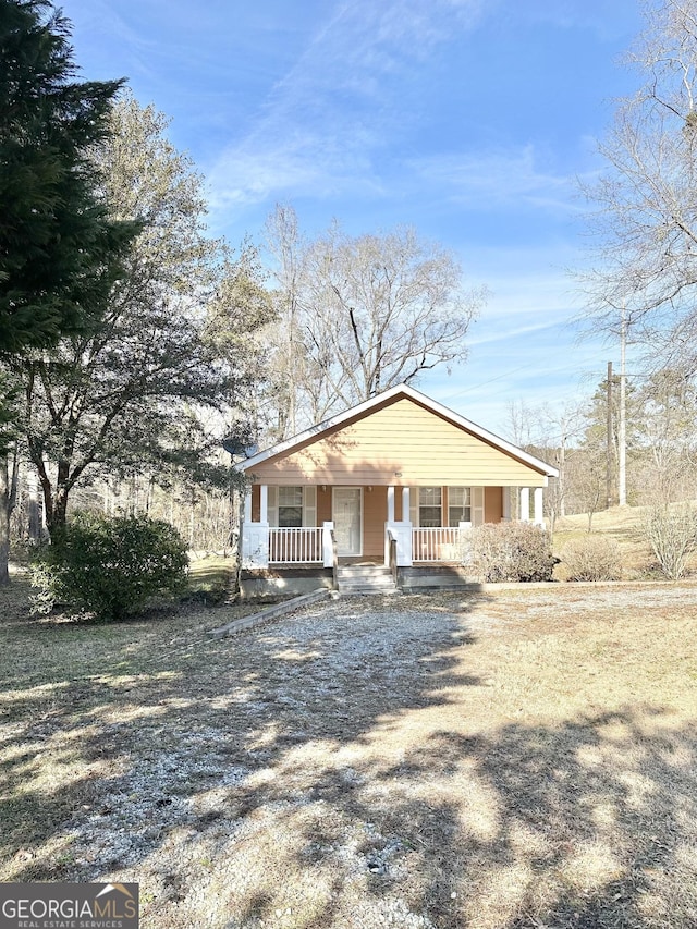 bungalow-style house with covered porch and driveway