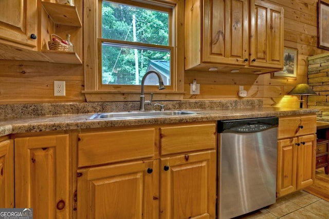 kitchen featuring light tile patterned floors, wood walls, a sink, dishwasher, and open shelves