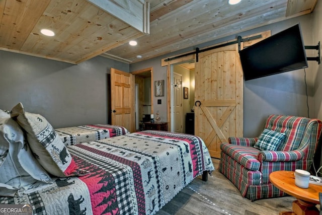 bedroom featuring recessed lighting, wooden ceiling, wood finished floors, and a barn door