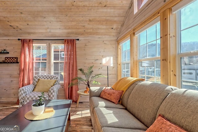 664 River Vista Dr, Dillard, GA 30537 - living room with wooden walls, vaulted ceiling, wood finished floors, and healthy amount of natural light