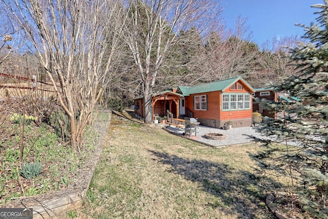 664 River Vista Dr, Dillard, GA 30537 - view of front of house featuring a front yard, a patio, and a metal roof