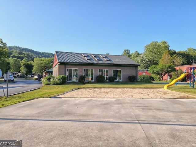664 River Vista Dr, Dillard, GA 30537 - view of front facade featuring a playground, a metal roof, and a front yard