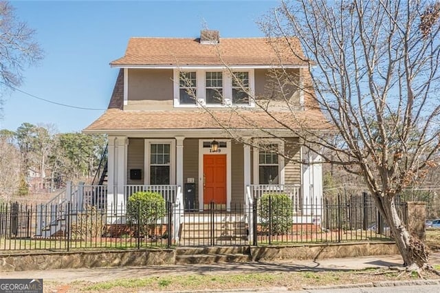 view of front of house with a fenced front yard, a porch, and a shingled roof