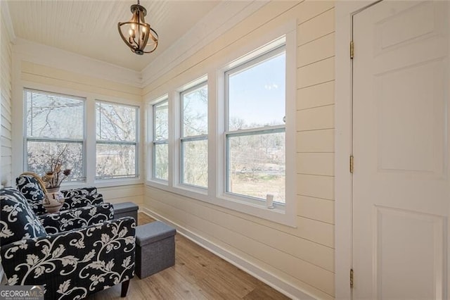 living area featuring baseboards and wood finished floors