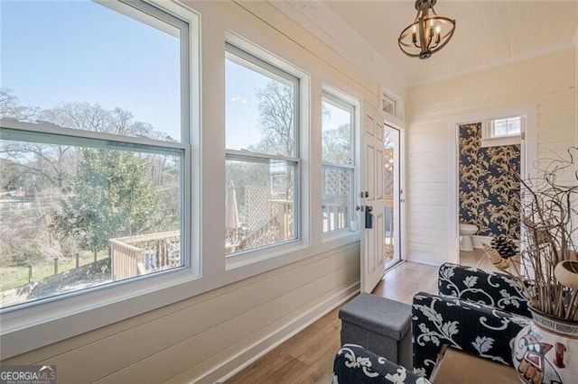 sunroom with an inviting chandelier and a healthy amount of sunlight