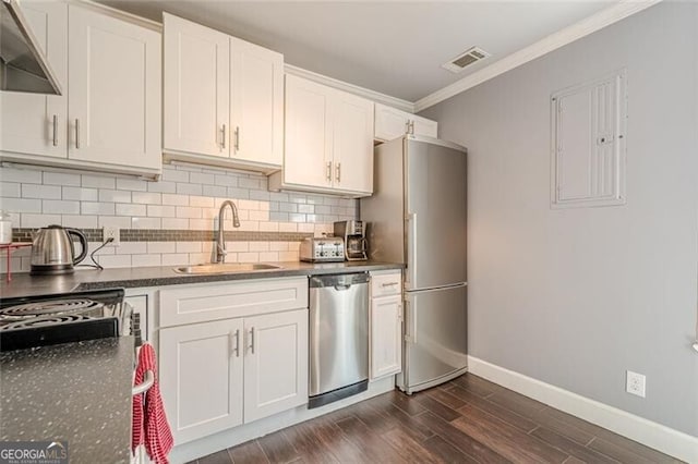 kitchen featuring visible vents, stainless steel dishwasher, freestanding refrigerator, a sink, and under cabinet range hood