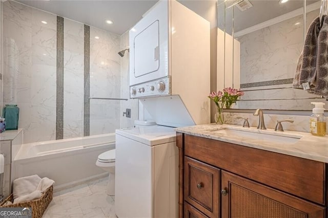 clothes washing area with recessed lighting, laundry area, a sink, marble finish floor, and stacked washer and clothes dryer