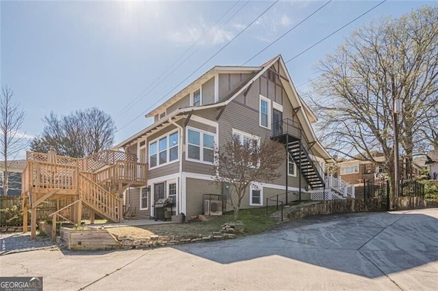 view of side of property featuring stairway