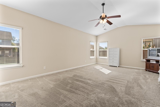 unfurnished bedroom with lofted ceiling, light colored carpet, ceiling fan, and baseboards