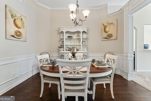 dining room with an inviting chandelier, arched walkways, dark wood finished floors, and ornamental molding