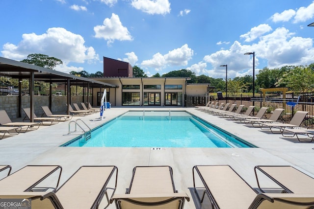 pool with fence and a patio