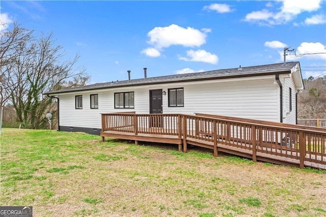 rear view of house featuring crawl space, a wooden deck, and a lawn